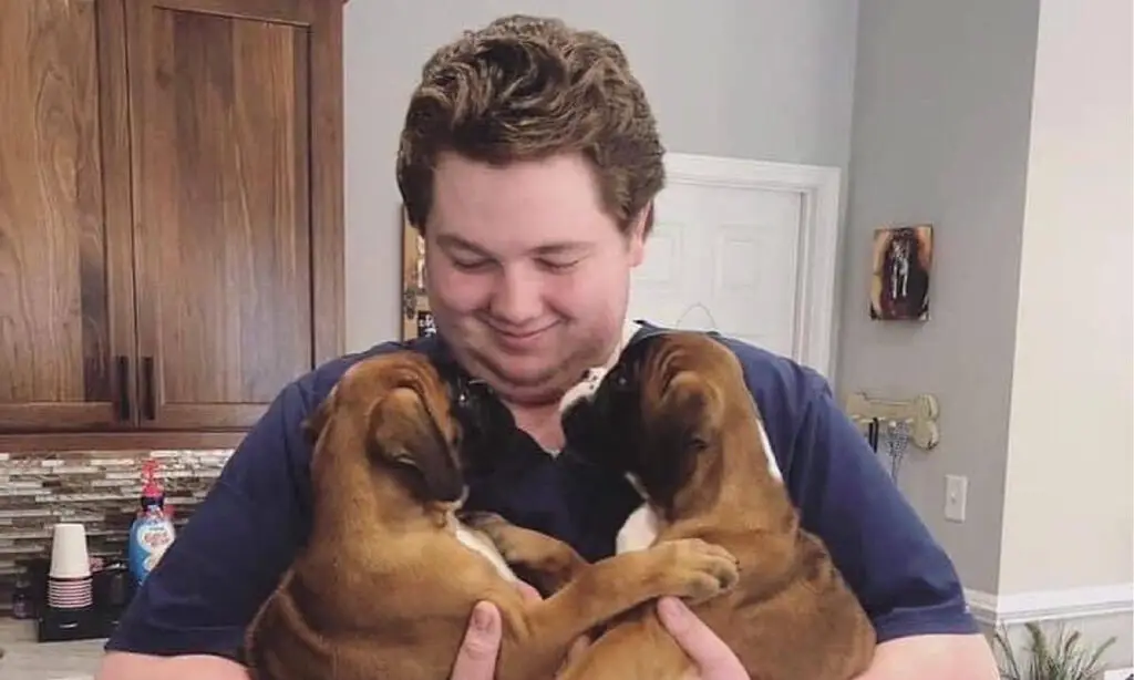 Veterinary staff holds two puppies in Roanoke, VA.